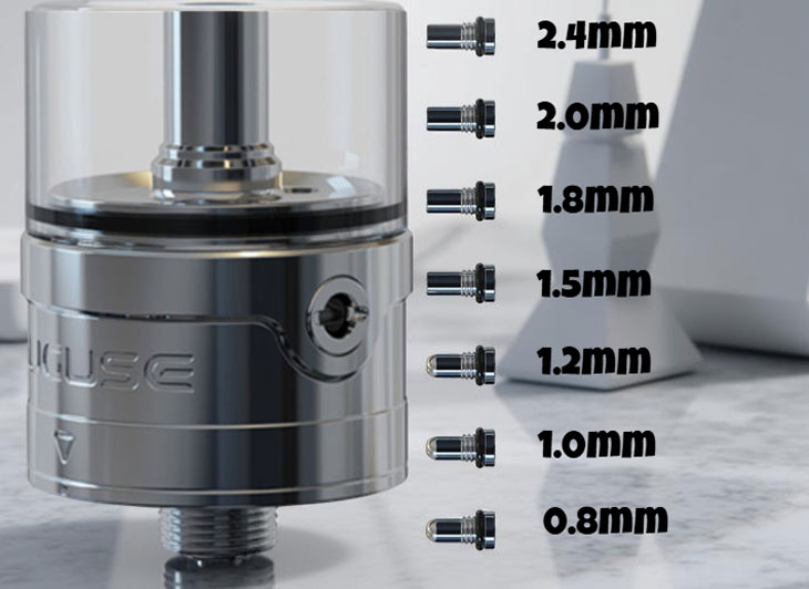Close-up of the Auguse Era RTA V3 next to a set of small metal airflow reducer pins, showcasing the wide range of airflow settings