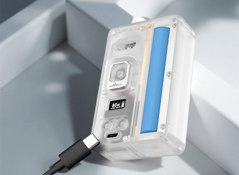 An internal view of the Vandy Vape Pulse AIO.5 highlighting the battery compartment with a single 21700 battery installed. To the side, a USB-C cable is shown approaching the dedicated charging port located just below the adjustment buttons