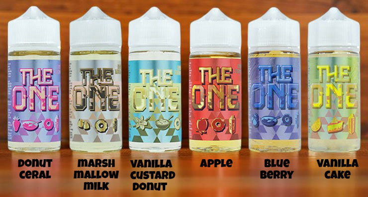A selection of e-liquid bottles from the Beard Vape Co. 'The One' collection, highlighting the dessert and breakfast-inspired flavors: Donut Cereal, Marshmallow Milk, Vanilla Cake, Vanilla Custard Donut, Apple, and Blueberry. The image showcases the signature packaging of the premium e-juice line.