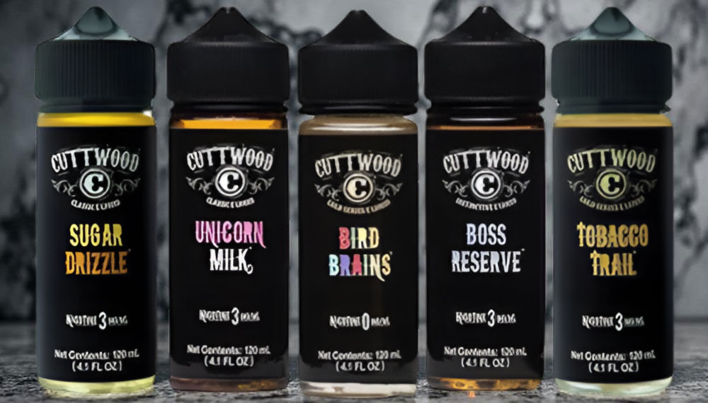 Cuttwood e-liquid bottles featuring five complex flavors: Sugar Drizzle, Unicorn Milk, Bird Brains, Boss Reserve, and Tobacco Trail