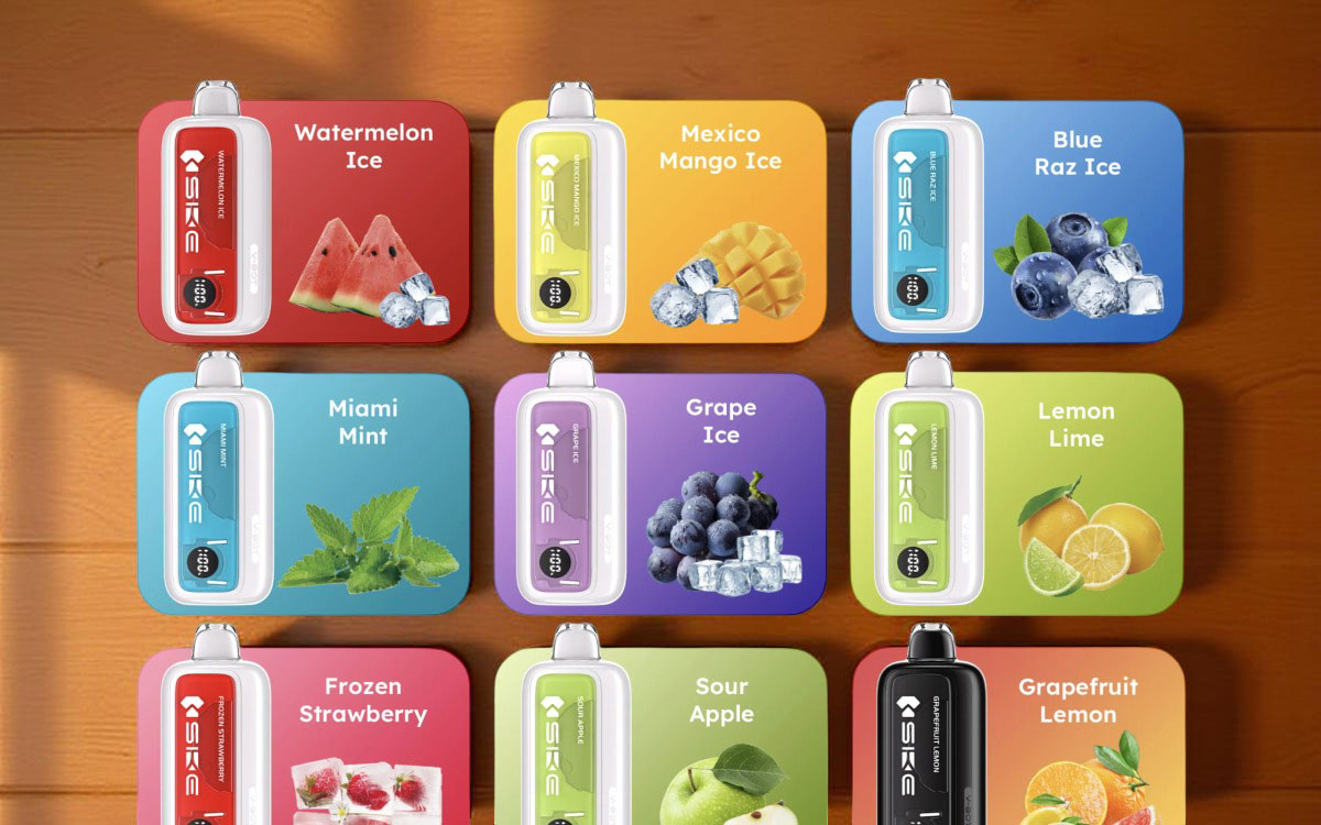 A promotional display featuring nine SKE V-BOT disposable vapes arranged in a grid, each showcasing a distinct flavor with vibrant color-coded packaging and a large digital screen. The featured flavors include Watermelon Ice, Mexico Mango Ice, Blue Raz Ice, Miami Mint, Grape Ice, Lemon Lime, Frozen Strawberry, Sour Apple, and Grapefruit Lemon.