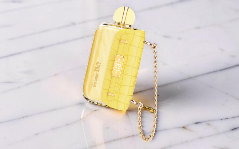 A yellow APUS Chloe 50K disposable vape styled like a miniature luxury purse with a functional chain strap, representing the tangy Citrus Lemon Head flavor.